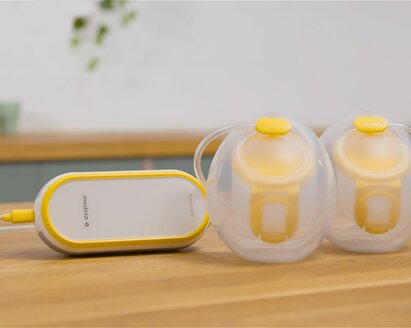 Medela Freestyle™ Hands-free double electric wearable breast pump sitting on counter