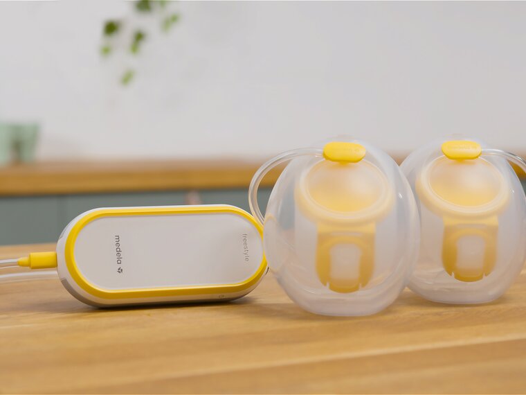 Medela Freestyle™ Hands-free double electric wearable breast pump sitting on counter