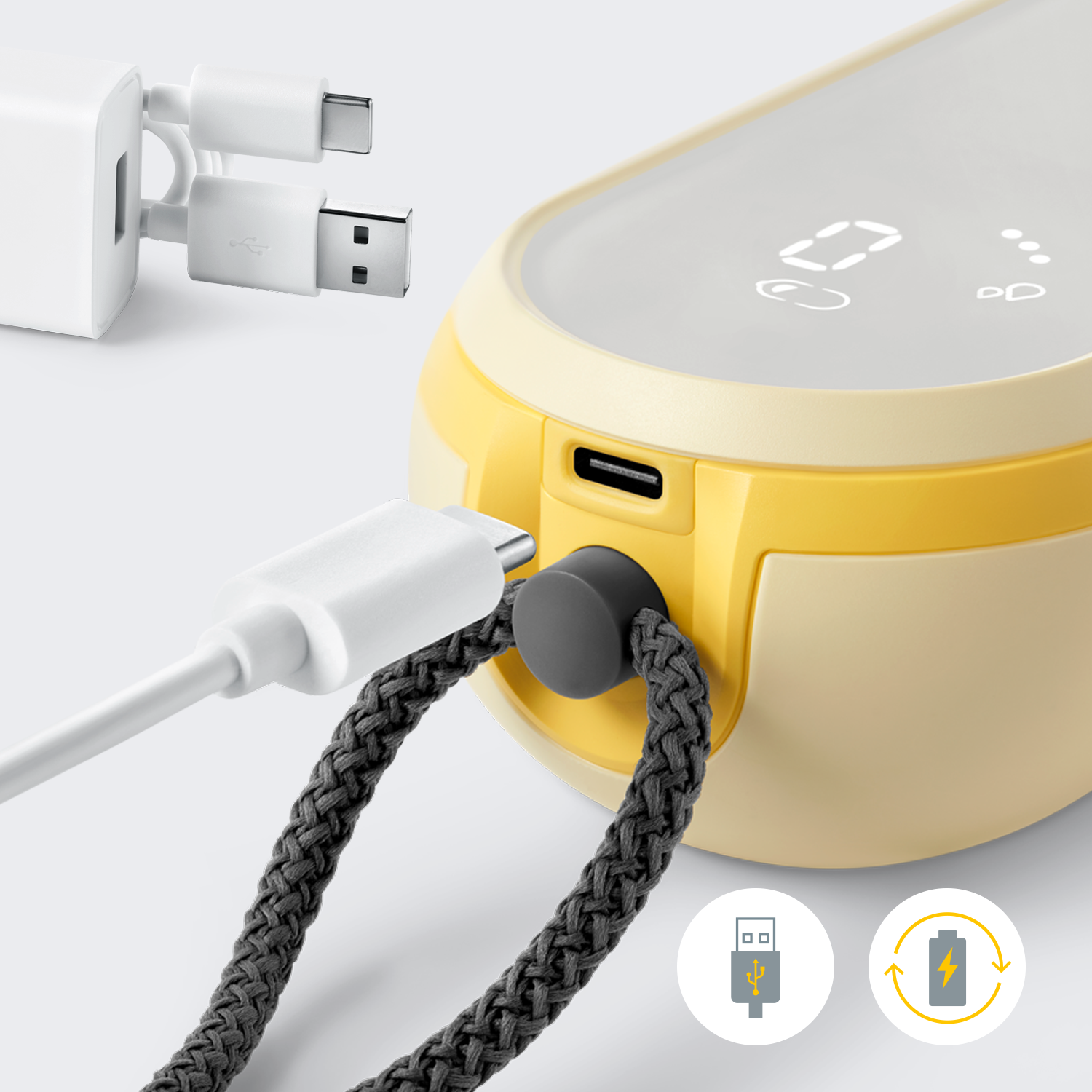 Close-up of Medela Freestyle™ Hands-free double electric wearable breast pump with the charger cord being inserted into the pump