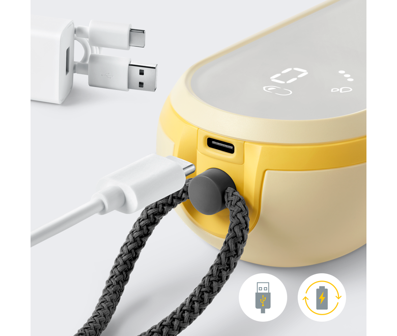 Close-up of Medela Freestyle™ Hands-free double electric wearable breast pump with the charger cord being inserted into the pump