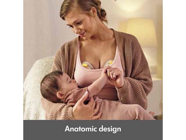Woman holding baby while pumping with the Medela Swing Maxi™ double electric breast pump.  Text at bottom of image says, "Anatomic design"