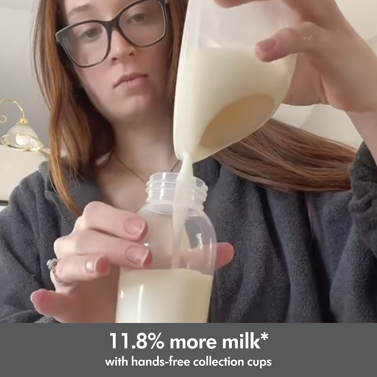 Mom pouring milk from her Medela Swing Maxi™ double electric breast pump's Hands-free collection cup into a storage container. Text below image reads, "11.8% more milk* with hands-free collection cups"