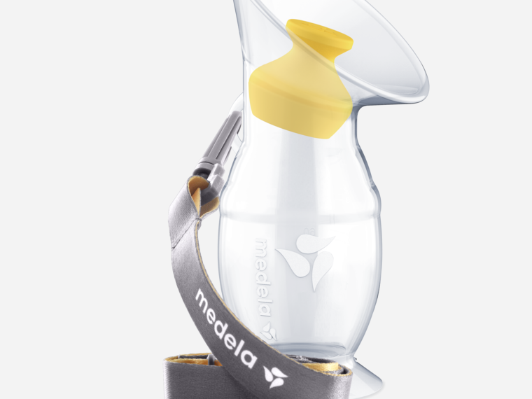 The Medela Silicone breast milk collector with stopper and lanyard.