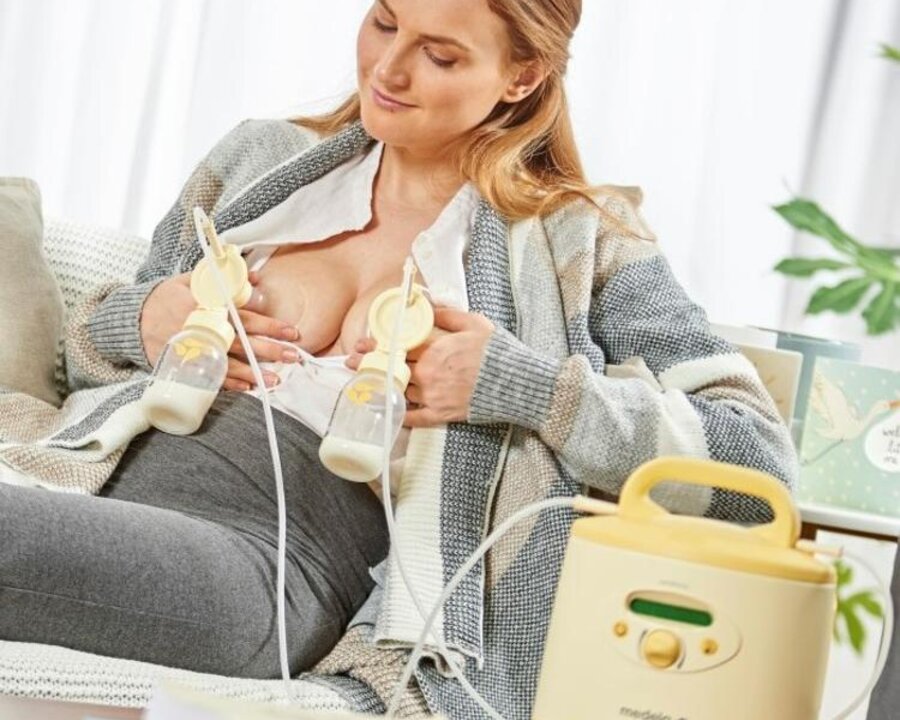 A mom uses a rental Medela Symphony PLUS® breast pump at home.