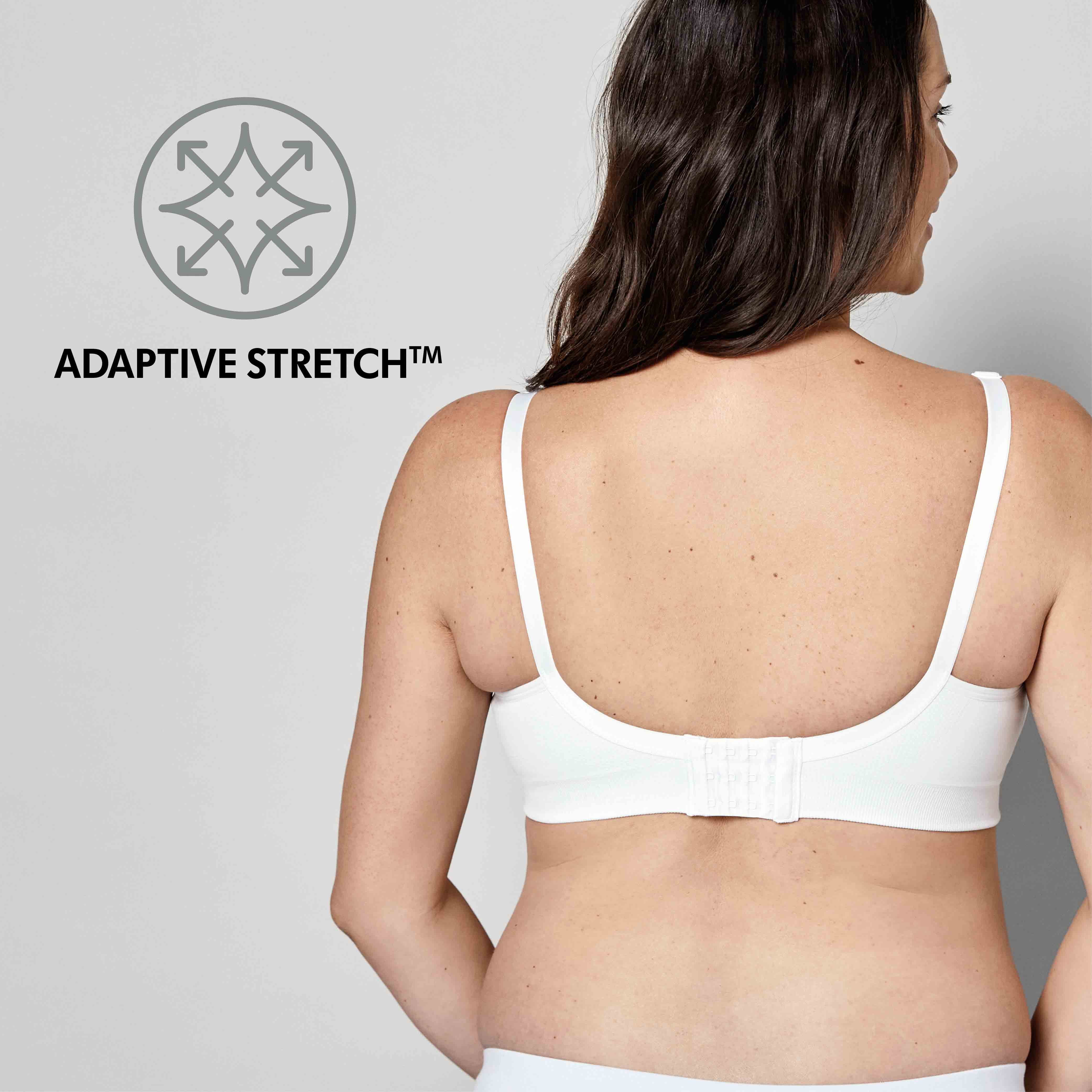 Woman wearing a white Medela Keep Cool™ Ultra Bra back view with text, "Adaptive Stretch"