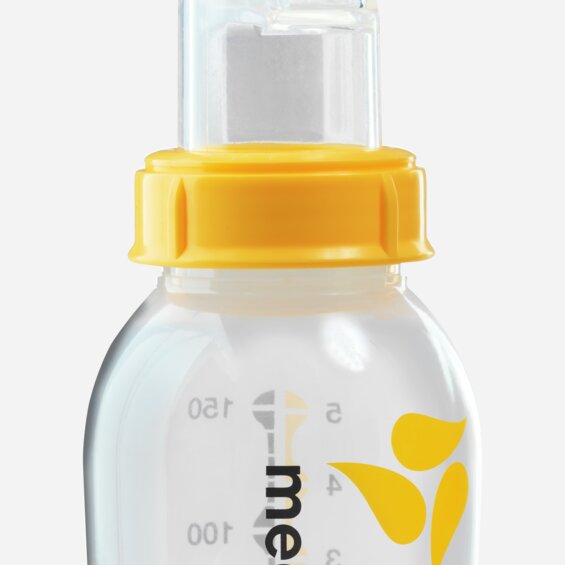An advanced cup feeder, the Medela SoftCup™. It is connected to a reusable Medela breast milk storage bottle.