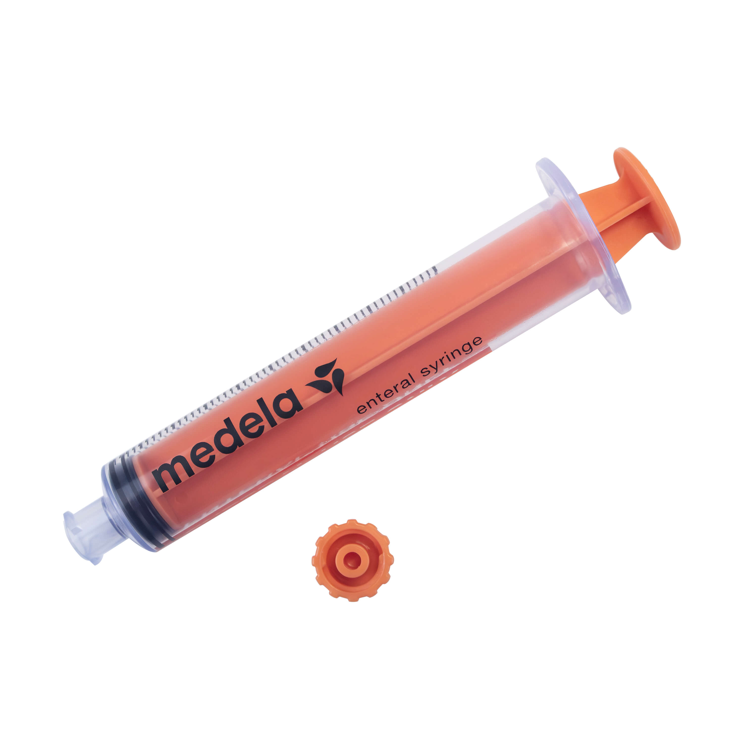 ENFit Syringe with plunger pushed down and cap sitting to the side.