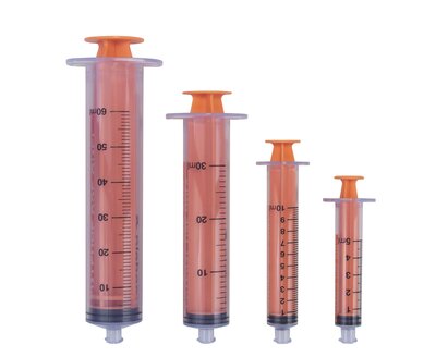 Various sizes of ENFit Syringes from 5 mL to 60 mL, all with plungers pushed in and caps removed.