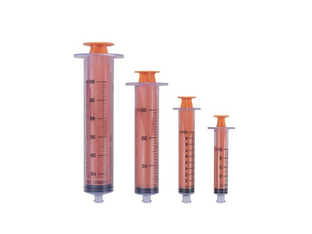Various sizes of ENFit Syringes from 5 mL to 60 mL, all with plungers pushed in and caps removed.