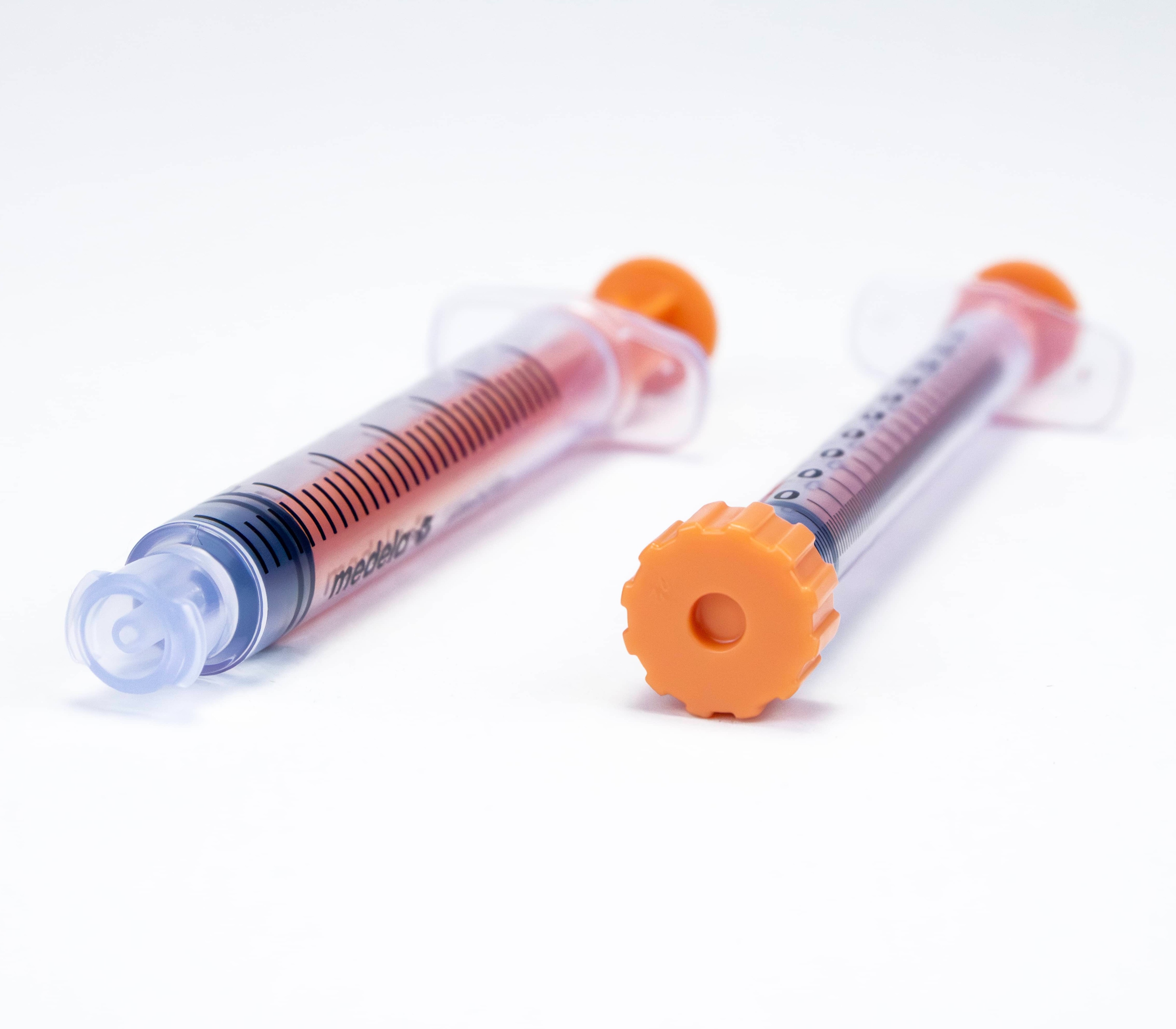 Multiple sizes of syringes both with the cap and with the cap removed.