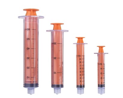 Various sizes of TwistLok syringes with plungers pushed down.