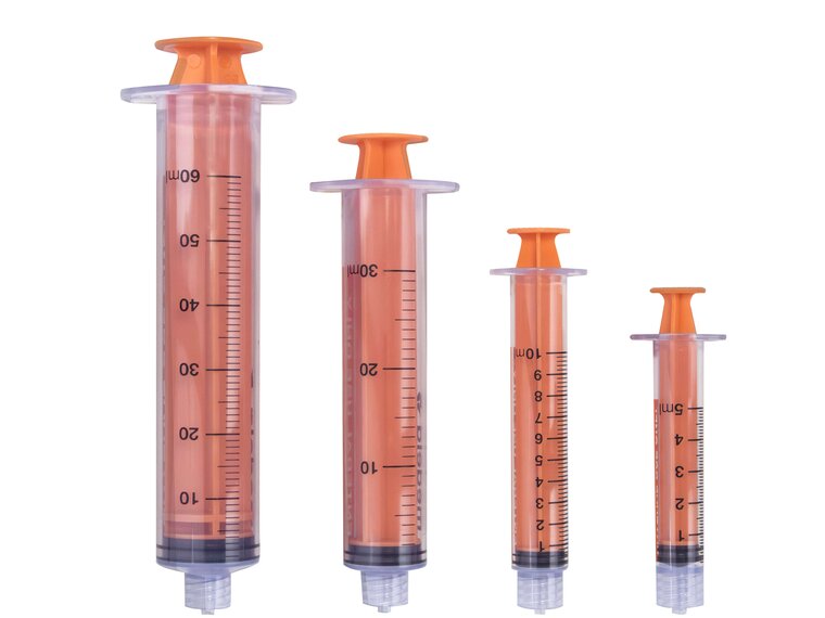 Various sizes of TwistLok syringes with plungers pushed down.