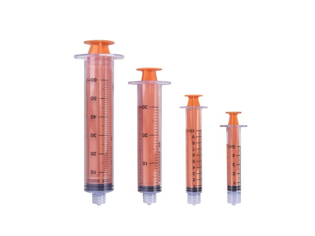 Various sizes of TwistLok syringes with plungers pushed down.