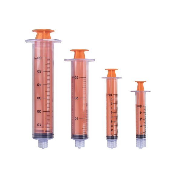 Various sizes of TwistLok syringes with plungers pushed down.
