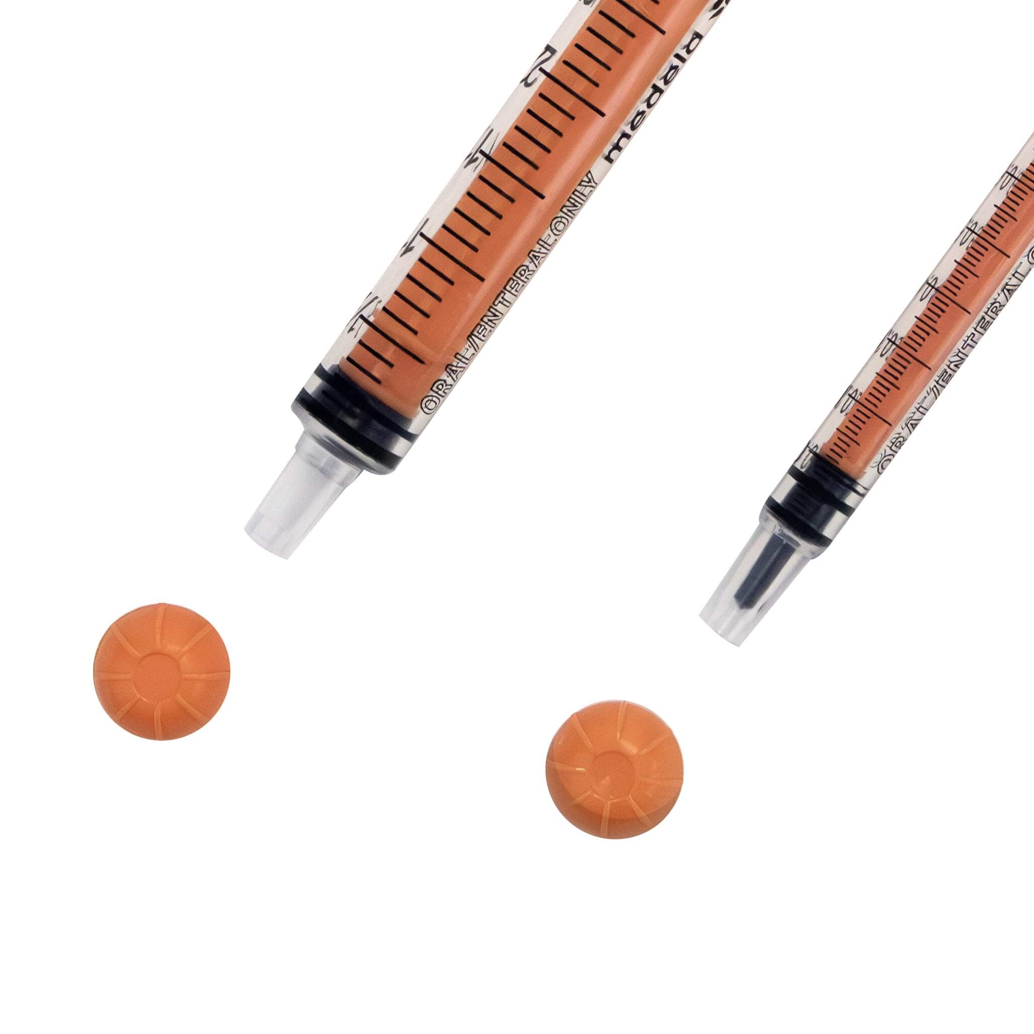 Close up of tip of two sizes of oral slip tip syringes.