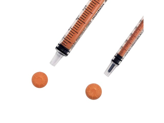 Close up of tip of two sizes of oral slip tip syringes.