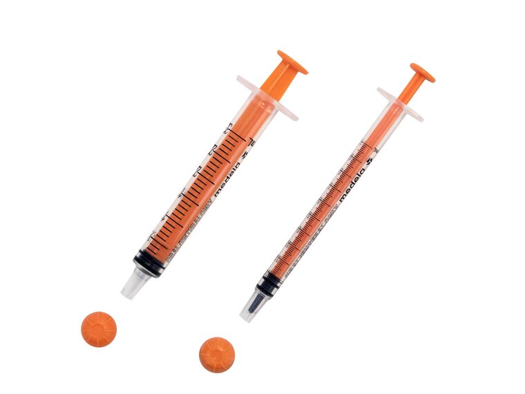 Medela Oral Syringes Two sizes of oral slip tip syringes with caps removed.