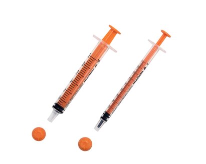 Two sizes of oral slip tip syringes with caps removed.