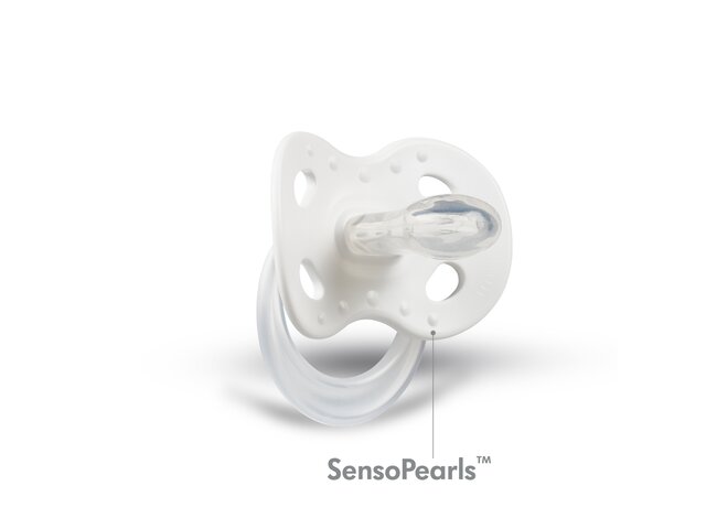 The inner side view of a white Medela Original dummy with an arrow and the text “SensoPearls™” for gentle skin contact.