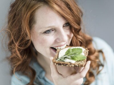 A mother eating a healthy diet to support good nutrition during breastfeeding.