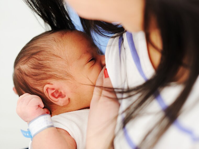 A new mom breastfeeds her newborn.