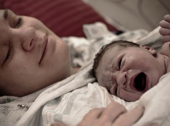 Une mère est allongée avec son nouveau-né sur la poitrine immédiatement après l'accouchement.