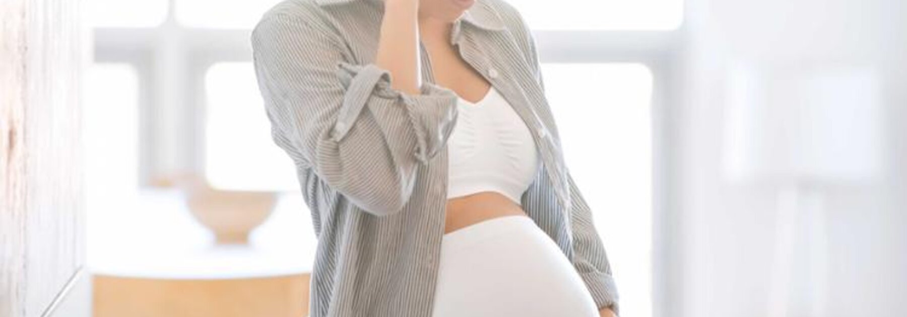 Eine schwangere Frau trägt ein Bauchband.