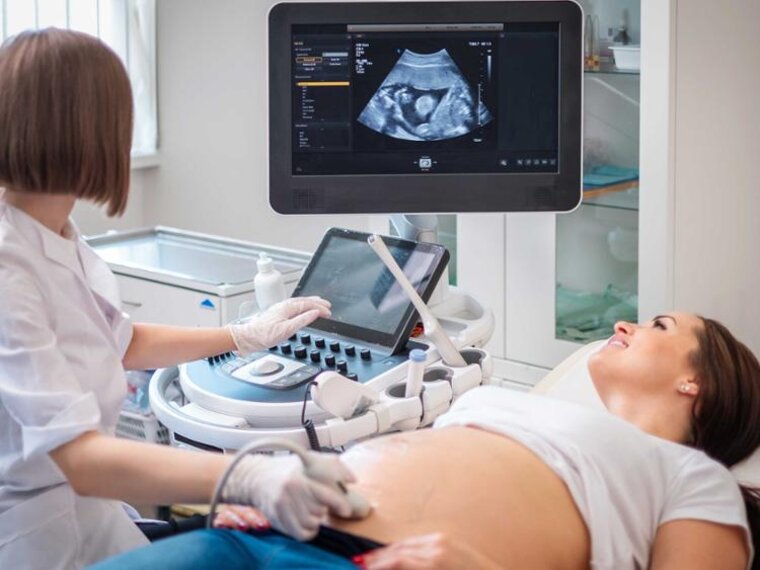 A pregnant woman receiving an ultrasound scan.