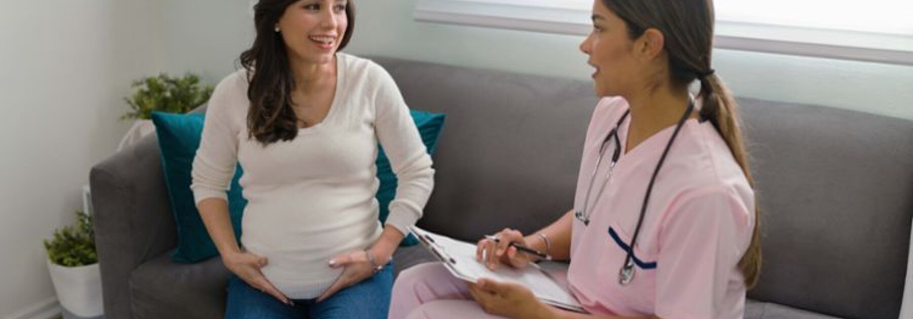 Pregnant mom having consultation with a midwife.