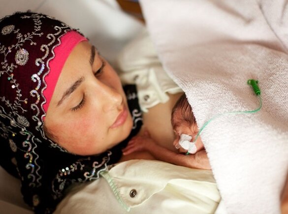 A premature baby has skin-to-skin contact with its mother.