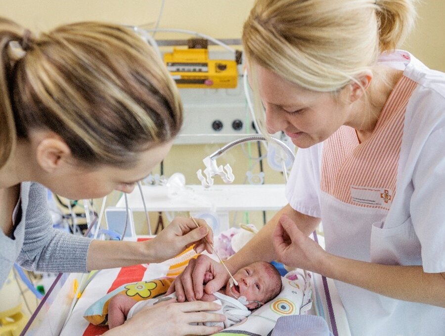 A premature baby receives oral therapy in the NICU.