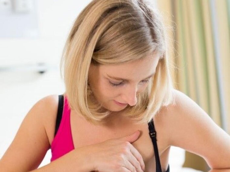 A new mother checks to see if her breast milk is coming in.