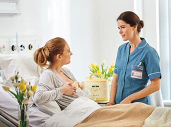 Una madre riceve da un'infermiera dell'ospedale consigli sull'uso del tiralatte Symphony®.