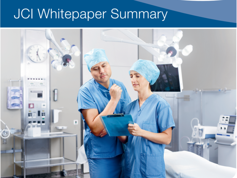 A doctor and nurse discuss medical treatment in an operating room.