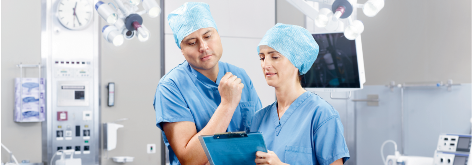 Professional Vacuum Systems A doctor and nurse discuss medical treatment in an operating room.