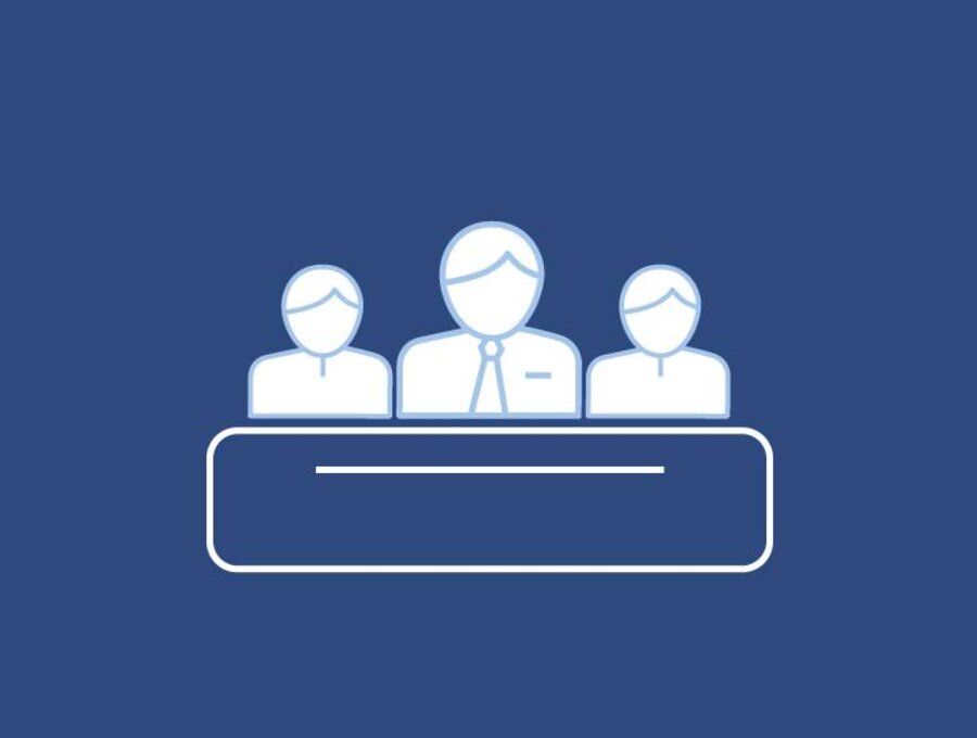 A blue and white illustration with three people sitting behind a table.