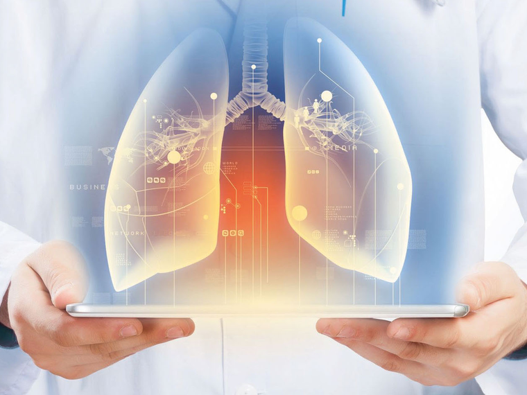 A graphic representation of the lungs on a tablet held by a healthcare professional.