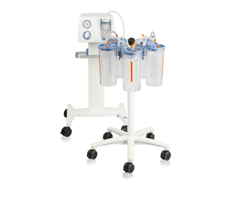 The mobile Medela Dominant Flex surgical suction pump and a trolley with several 2500cc disposable jars with liners.