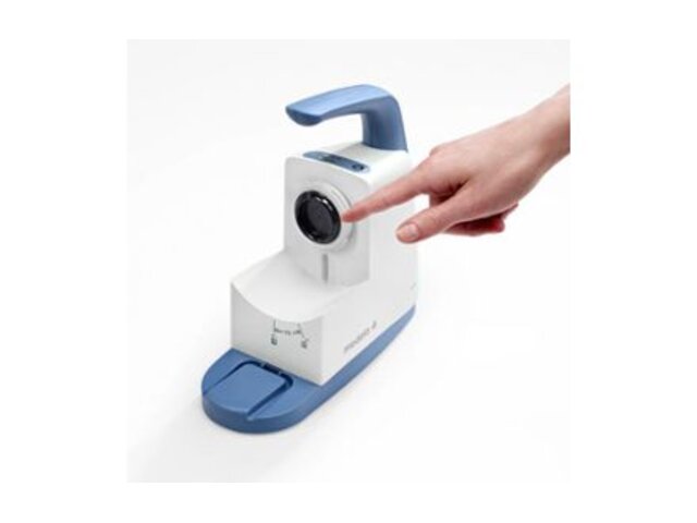 A hand pointing to the membrane of the Medela Clario Airway Suction Pump.