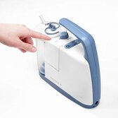 A person points to the Vacuum Regulator knob from the side of the Clario airway suction pump.