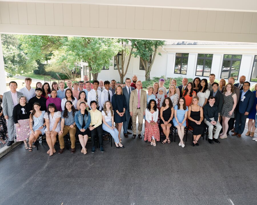 Two photos stacked. Top shows Medela factory workers holding new products.  Lower photo shows Medela colleagues with employment service awards.