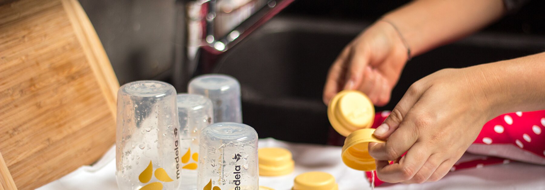 Breast milk storage bottles A mother washes Medela breast milk bottles and lays them on a towel to dry.