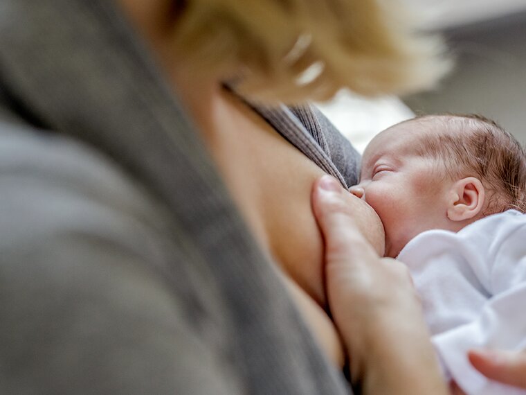 A mum breastfeeds her premature baby.