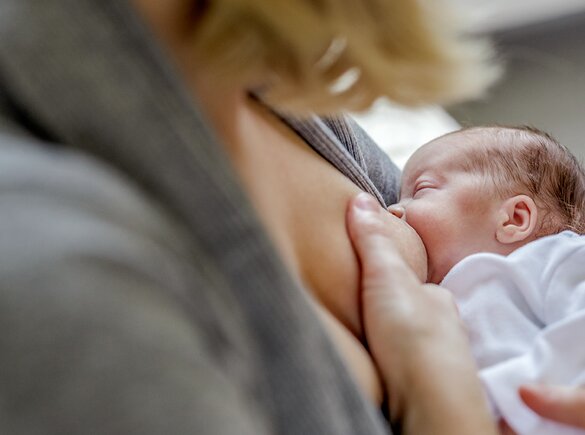 A mum breastfeeds her premature baby.