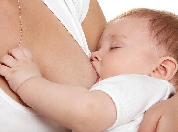 A close-up of a mom breastfeeding her baby.